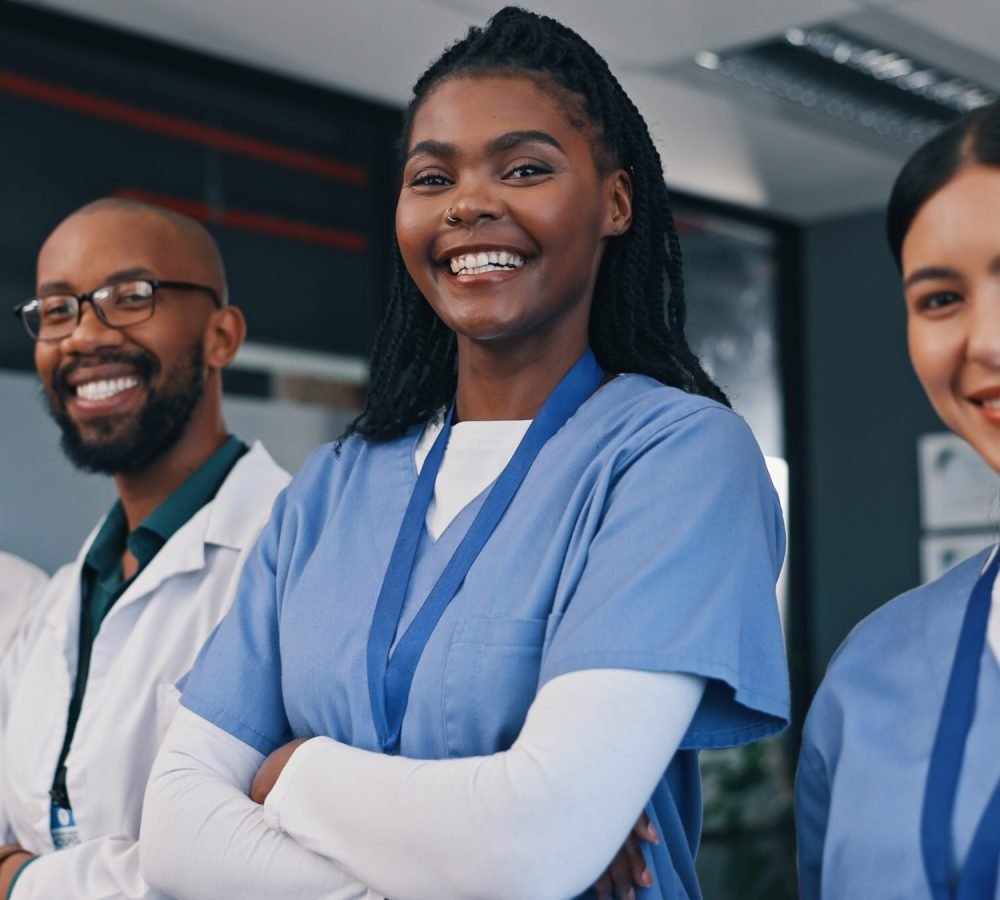 Doctors, group and happy with arms crossed in hospital with confidence in medical goals or mission